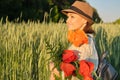 Outdoor portrait of happy mature woman with bouquets of red poppies flowers Royalty Free Stock Photo