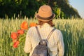 Outdoor portrait of happy mature woman with bouquets of red poppies flowers Royalty Free Stock Photo