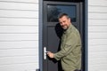 Outdoor portrait of happy middle aged caucasian man front home door Royalty Free Stock Photo