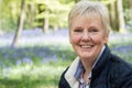 Outdoor Portrait Of Happy Senior Woman In Bluebell Wood Royalty Free Stock Photo