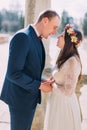 Outdoor portrait of happy sensual wedding pair embracing. Beautiful young bride going to kiss with handsome groom Royalty Free Stock Photo