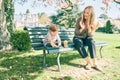 Outdoor portrait of happy young mother playing with adorable baby girl in spring park Royalty Free Stock Photo