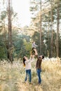 Outdoor portrait of happy young parents, having fun and lifting up their little cute baby son, during walk in autumn Royalty Free Stock Photo