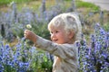 Outdoor portrait of little cute blond boy holding daisy flower Royalty Free Stock Photo