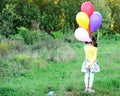 Outdoor portrait of little girl with balloons