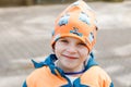 Outdoor portrait of little kid boy in spring or autumn colorful clothes. Happy boy having fun in a zoo. Smiling child Royalty Free Stock Photo