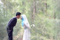 Outdoor portrait of a lovely malay wedding couple in a beautiful park.