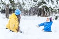 Outdoor portrait Mother and child playing in the winter park. showered with snow Royalty Free Stock Photo