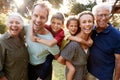 Outdoor Portrait Of Multi-Generation Family Walking In Countryside Against Flaring Sun Royalty Free Stock Photo