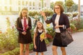 Outdoor portrait of a parent and children on the way to school Royalty Free Stock Photo