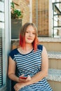 Outdoor portrait of pretty teenage girl with red dyed hair Royalty Free Stock Photo