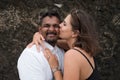 Outdoor portrait of romantic kissing young couple in sandy beach. Royalty Free Stock Photo