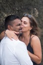 Outdoor portrait of romantic kissing young couple in sandy beach. Royalty Free Stock Photo