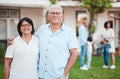 Outdoor, portrait and senior couple by their house embracing while bonding with their family. Love, smile and happy Royalty Free Stock Photo