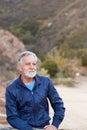 Outdoor Portrait Of Serious Hispanic Senior Man With Mental Health Concerns