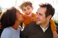 Outdoor Portrait Of Smiling Family In Garden At Home Against Flaring Sun Royalty Free Stock Photo