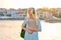 Outdoor portrait of female student teenager in headphones with backpack and laptop Royalty Free Stock Photo