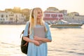 Outdoor portrait of female student teenager in headphones with backpack and laptop Royalty Free Stock Photo