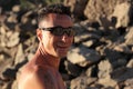 Outdoor portrait of smiling man with Oakley sunglasses