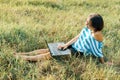 Outdoor portrait smiling middle-aged woman freelancer blogger traveler with laptop on nature Royalty Free Stock Photo