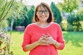 Outdoor portrait of smiling middle aged woman looking at camera Royalty Free Stock Photo