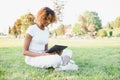 Outdoor portrait of a smiling teenage black girl using a tactile tablet - African people Royalty Free Stock Photo