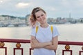 Outdoor portrait of smiling teenage girl of 15, 16 years old with folded arms Royalty Free Stock Photo