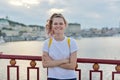 Outdoor portrait of smiling teenage girl of 15, 16 years old with folded arms Royalty Free Stock Photo