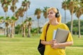 Outdoor portrait of teenage female student with laptop backpack. Royalty Free Stock Photo