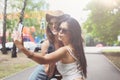 Outdoor portrait of three friends take selfie with smartphone Royalty Free Stock Photo