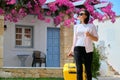 Outdoor portrait of tourist woman with suitcase at hotel sea spa resort, copy space Royalty Free Stock Photo