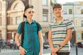 Outdoor portrait of two friends boys teenagers 13, 14 years old talking and laughing on city street Royalty Free Stock Photo