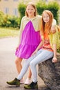 Outdoor portrait of two funny preteen girls