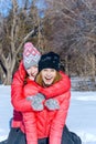 Outdoor portrait of two girls have fun and enjoy the fresh snow on a beautiful winter day in winter park Royalty Free Stock Photo