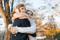 Outdoor portrait of two little girls best friends, smiling girls hugging each other watching the sunset, sunny autumn winter park Royalty Free Stock Photo