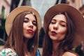Outdoor portrait of two young beautiful fashionable women taking selfie. Girls having fun in city. Best friends Royalty Free Stock Photo