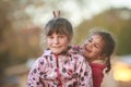 Outdoor portrait of two young happy children, girls - sisters - Royalty Free Stock Photo