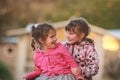 Outdoor portrait of two young happy children, girls - sisters - Royalty Free Stock Photo