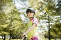 outdoor portrait of a white happy girl riding a bike on natural background Royalty Free Stock Photo