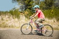 outdoor portrait of a white happy girl riding a bike on natural background Royalty Free Stock Photo