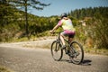 outdoor portrait of a white happy girl riding a bike on natural background Royalty Free Stock Photo