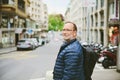 Outdoor portrait of 55-60 year old man wearing blue jacket and backpack Royalty Free Stock Photo