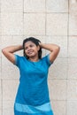 Outdoor portrait of a young African American girl. Beige background. Lifestyle. Clothing