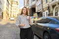 Outdoor young business woman with laptop bag paper cup of coffee walking along street Royalty Free Stock Photo