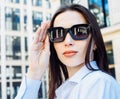 Outdoor portrait of a young beautiful confident woman with long hair posing on the street. Royalty Free Stock Photo