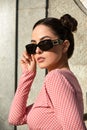Outdoor portrait of a young beautiful confident woman posing on the street. Model wearing stylish sunglasses. Girl Royalty Free Stock Photo
