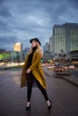 Outdoor portrait of a young beautiful fashionable lady wearing olive coat Royalty Free Stock Photo