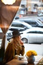 Outdoor portrait of a young beautiful fashionable lady wearing olive coat Royalty Free Stock Photo