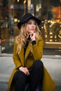 Outdoor portrait of a young beautiful fashionable lady wearing olive coat Royalty Free Stock Photo