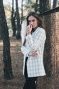 Outdoor Portrait of young beautiful fashionable woman wearing stylish white jacket. Model on the street. Women`s fashion concept Royalty Free Stock Photo